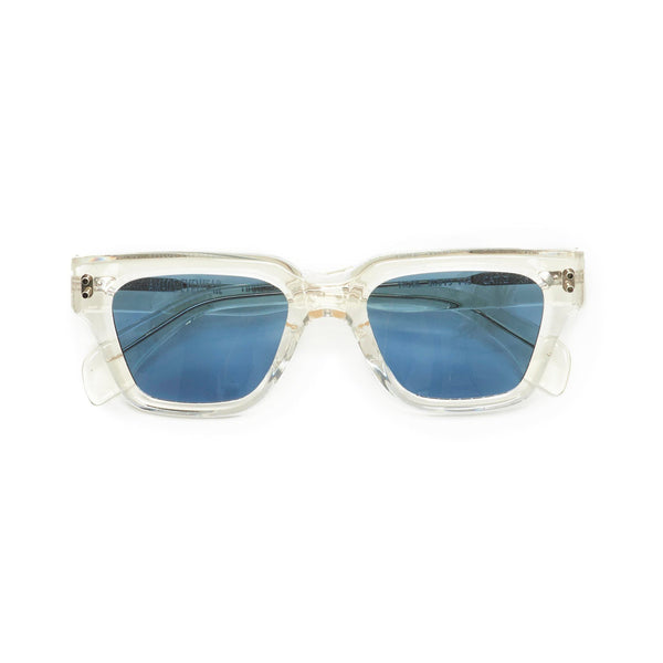 Transparent sunglasses frames with light blue lenses handmade in italy. Front view temples crossed