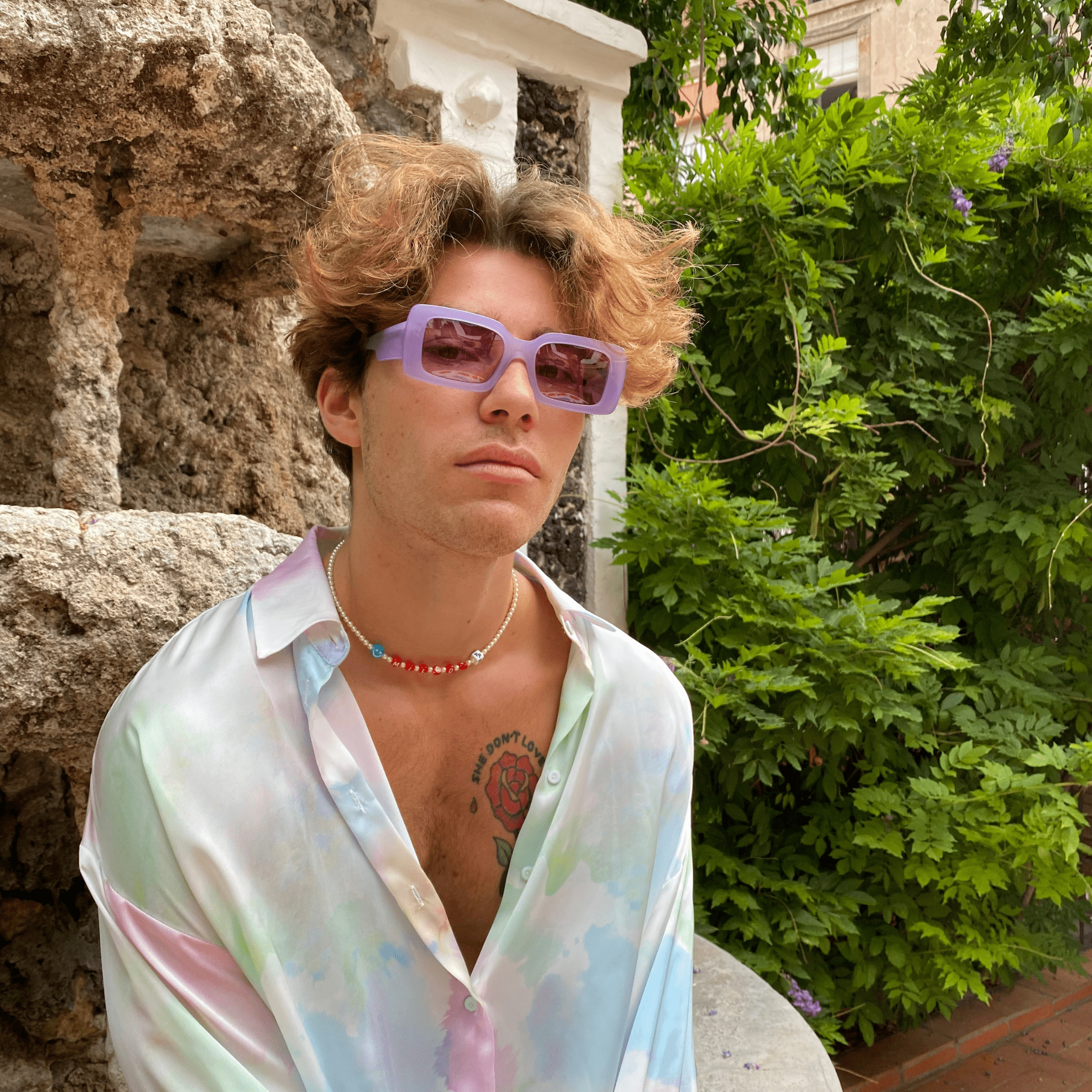 Purple sunglasses frames with pink lenses handmade in italy. Male model